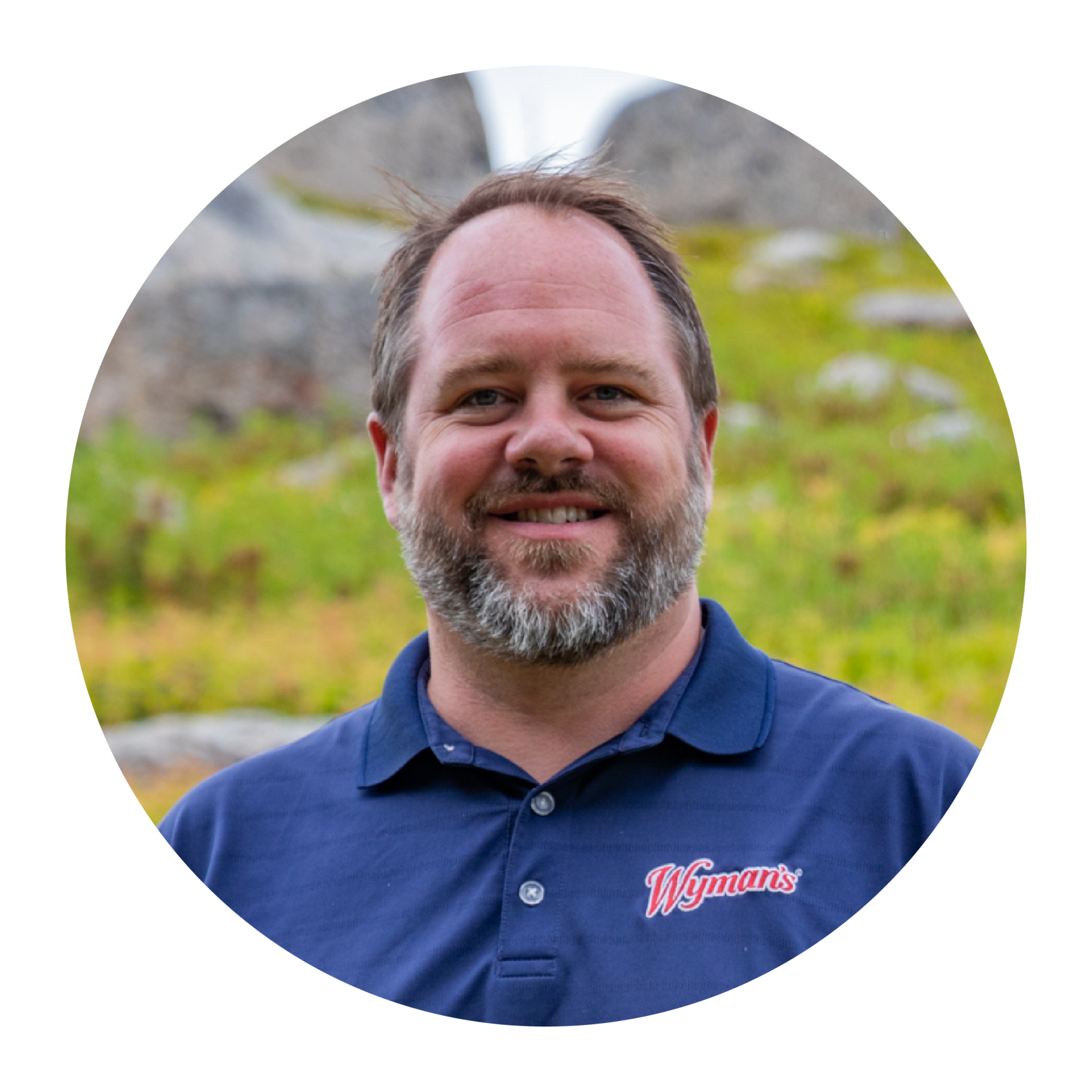 Bruce Hall of Wyman's standing in front of wild blueberries