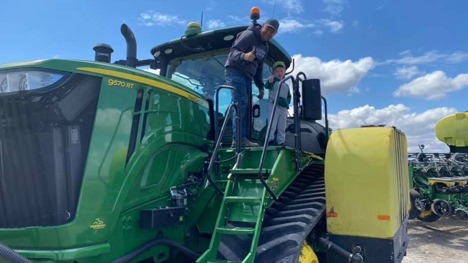 Chris Nelson on top of a John Deere planter