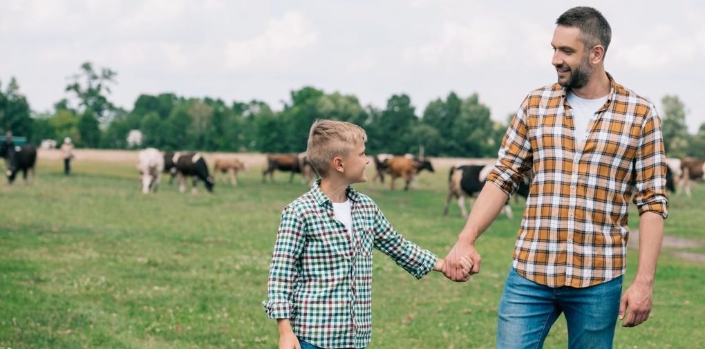 Dad and son on family dairy farm